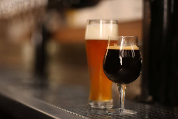 istock Different beers in glasses on bar counter, space for text 1351241626