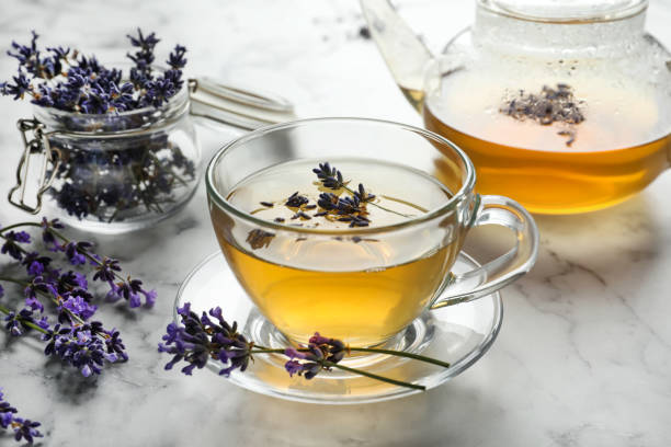 istock Fresh delicious tea with lavender and beautiful flowers on white marble table 1351244021