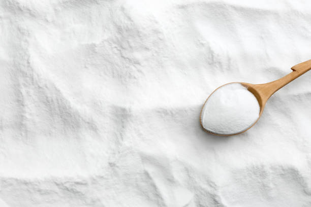 istock Wooden spoon on baking soda. Space for text 1351244594