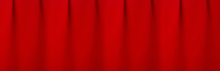 Deep red velvet curtain with smooth folds as elegance classic cinema background. Banner for design of website, header, cover.