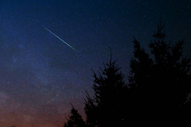 istock Evening sky with meteor, shooting stars and Milky Way. 1351249994