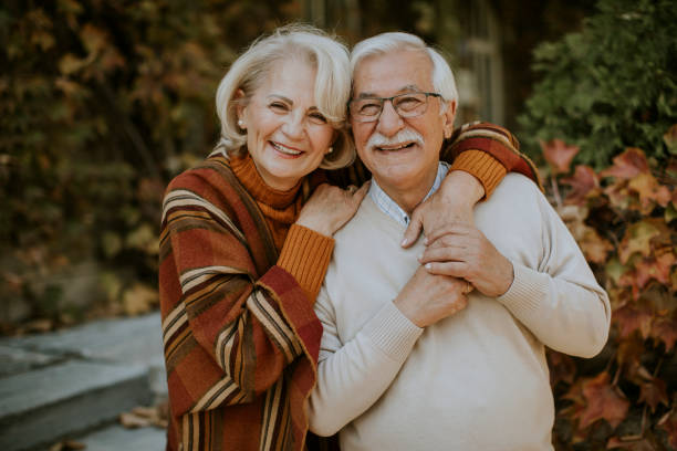 istock Senior couple embracing in autumn park 1351254564