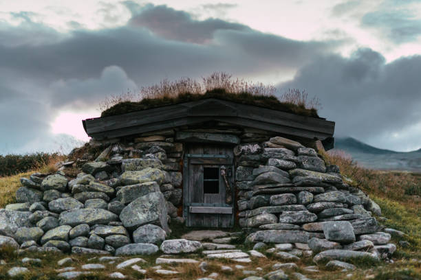 istock Exploring wilderness. Mysterious mountain landscape with stone building. Scandinavian descent 1351256552