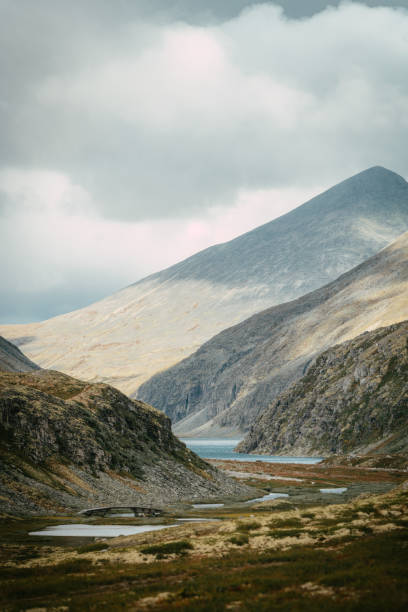 istock Exploring wilderness. Mysterious mountain landscape and lakes. Scandinavian descent 1351256601