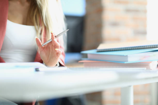 istock Woman holding silver pen for writing 1351257333