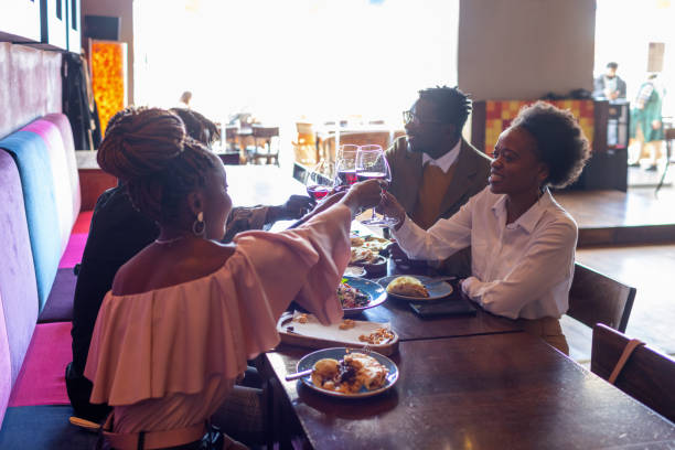 istock Happy Young Friends Enjoy In Restaurant 1351257682