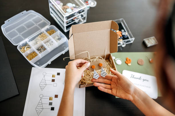 istock Young unrecognisable woman preparing her earrings for delivery 1351260306