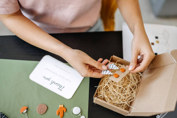 istock Young unrecognisable woman preparing her earrings for delivery 1351260313