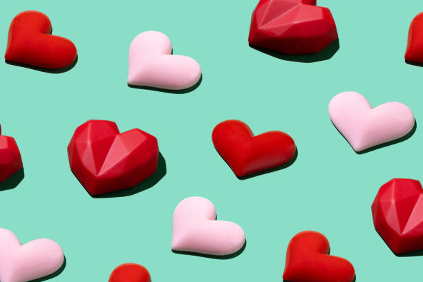 istock Pink and red hearts pattern on light pastel green background for Valentine’s Day 1351261609