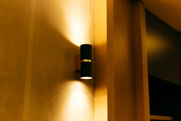 istock Warm black lamp on a beautiful wooden wall. Indirect light. 1351261855