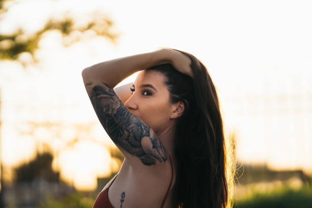 istock Sensual young woman posing in a park during sunset 1351265586