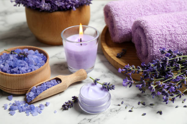 istock Cosmetic products and lavender flowers on white marble table 1351266707