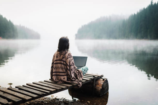 istock Woman Relaxing In Nature And Using Technology 1351267330