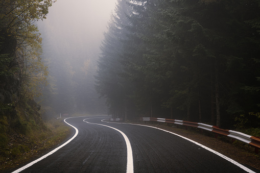 Curved Transfagarasan road in Romania on a foggy gloomy day