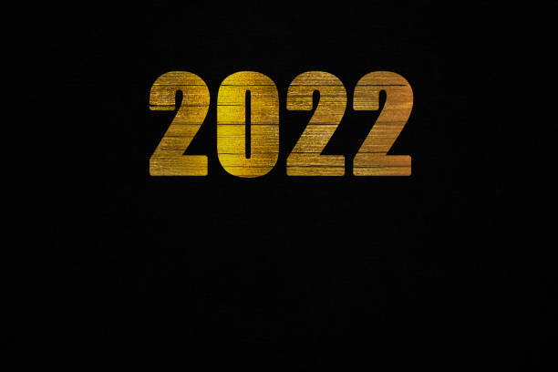 istock Golden Inscription 2022 on a Black canvas, year, date, background 1351269677