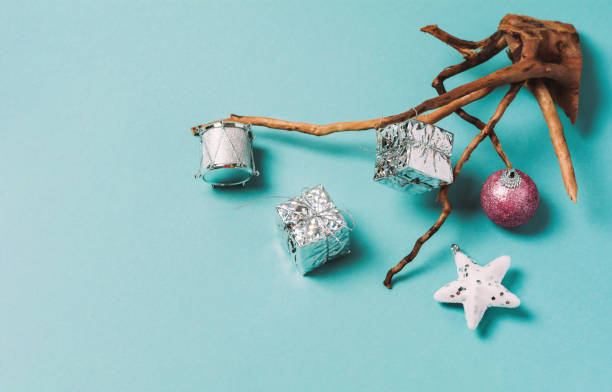 Wooden branch with christmas decorations on a blue background