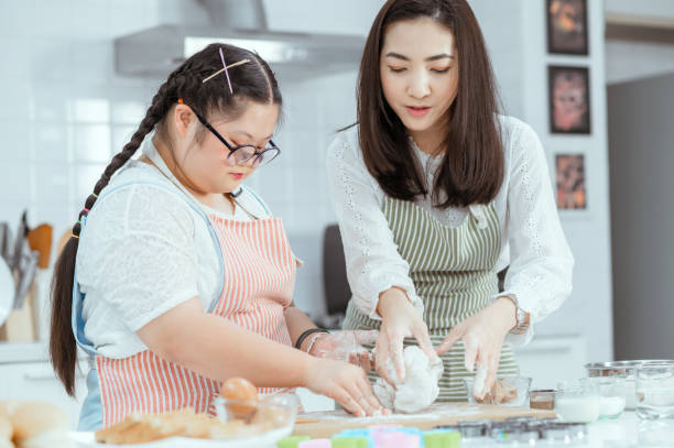istock Young Downs Syndrome Couple Baking In Kitchen At Home 1351271727