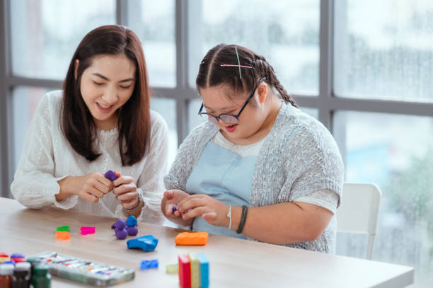 Autistic girl pursues a hobby of sculpting and painting. Autistic girl pursues a hobby of sculpting and painting. developmental disability stock pictures, royalty-free photos & images