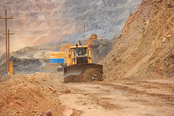 istock Bulldozer workflow for laying or leveling a technological road in a mining quarry 1351276513