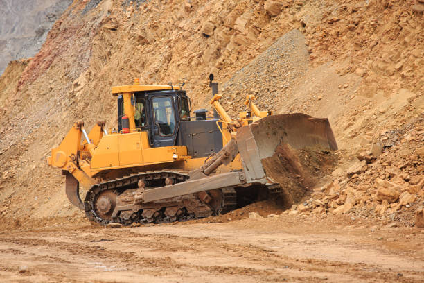 istock Bulldozer workflow for laying or leveling a technological road in a mining quarry 1351276519