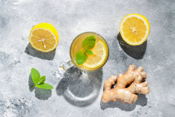 istock Cup of tea with lemon, ginger root and mint with long shadows 1351277294