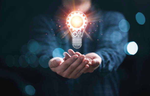 istock Businessman holding glowing light bulb with mechanical gear and orange light ray for inspiration creative thinking idea and future innovation technology  concept. 1351277870