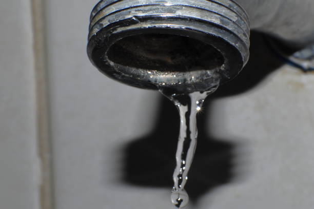 istock Water dripping from the tap, wasted water macro 1351281783