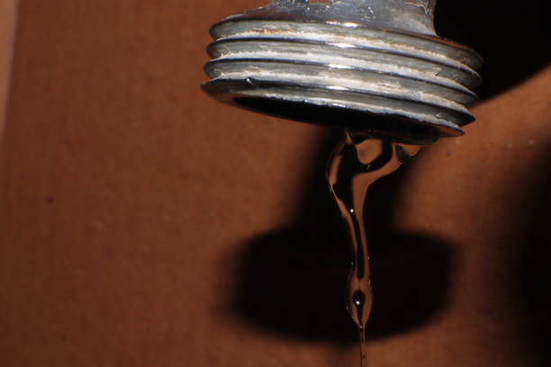 istock Water dripping from the tap, wasted water macro 1351281786