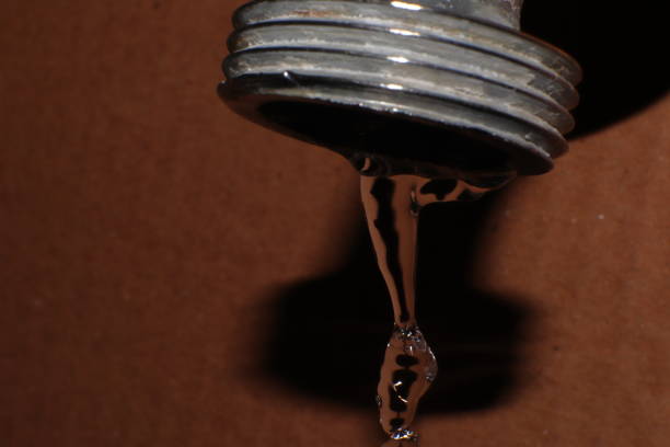 istock Water dripping from the tap, wasted water macro 1351281787
