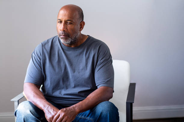 Portrait of a mature man looking sad and away from the camera. stock photo