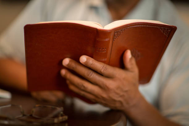 istock African American man praying and reading the Bible. 1351282122