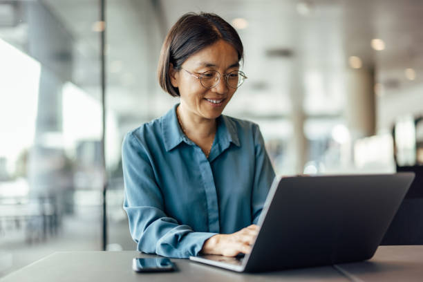 istock Smling asian office worker, coming up with new ideas 1351284325