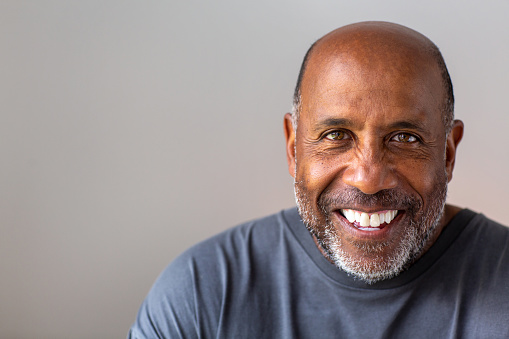 Happy attractive older African American man smiling.