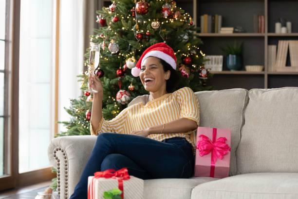 Happy young african woman celebrating Christmas at home.