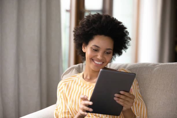 istock Happy african ethnicity woman using digital tablet. 1351285388