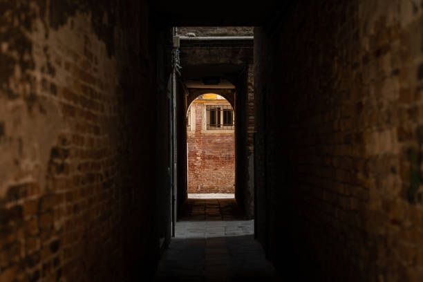 istock Dark narrow street in Venice 1351287138