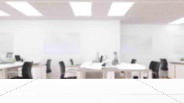 istock white desk on blurry office background,mock up 1351289026