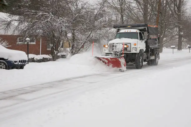 Photo of Snow plow removing snow from street.