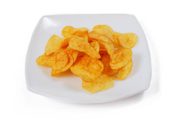 istock potato chips lie on a white plate, isolated on a white background 1351289657