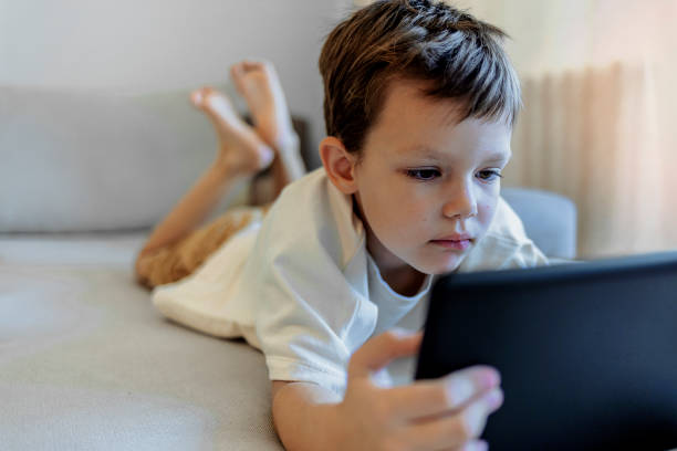 istock Small boy surfing the net on touchpad. 1351289822