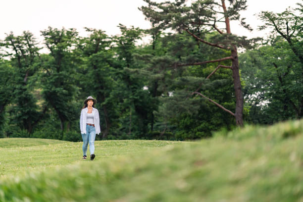 istock Young woman enjoying taking a walk alone in nature 1351291319