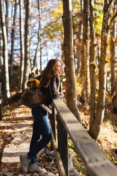 istock Hiker young woman enjoying the autumn forest 1351292349