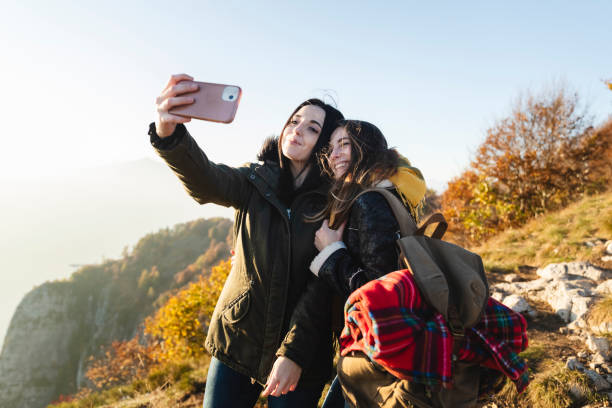 istock Young couple taking a selfie on top the hill 1351292381