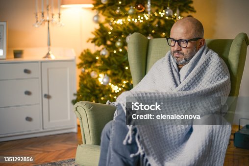 istock mature adult man in christmas home interior ( in plaid) 1351292856