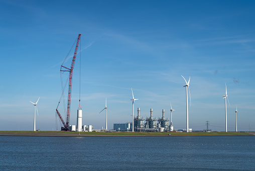 New wind turbines being constructed in the Netherlands during the energy transition.