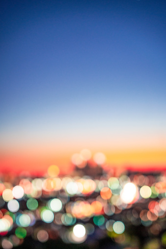 The Los Angeles skyline, photographed in the blue hour following sunset, intentionally defocused in the camera for use as a generic city skyline horizon.