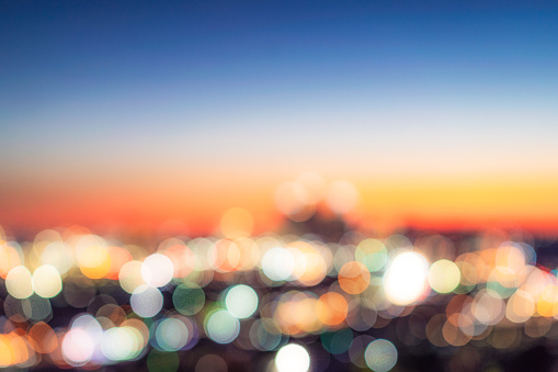The Los Angeles skyline, photographed in the blue hour following sunset, intentionally defocused in the camera for use as a generic city skyline horizon.