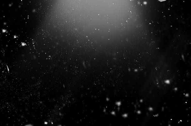 istock falling particles on a black background. can be used with screen overlay mode 1351297858