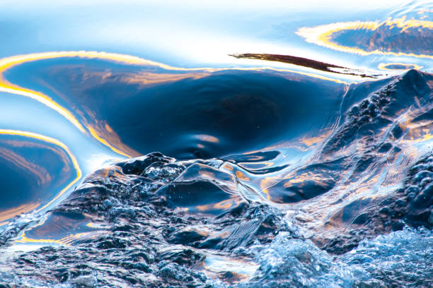 istock Light from the setting sun on the water-AuSable River, Michigan 1351299198