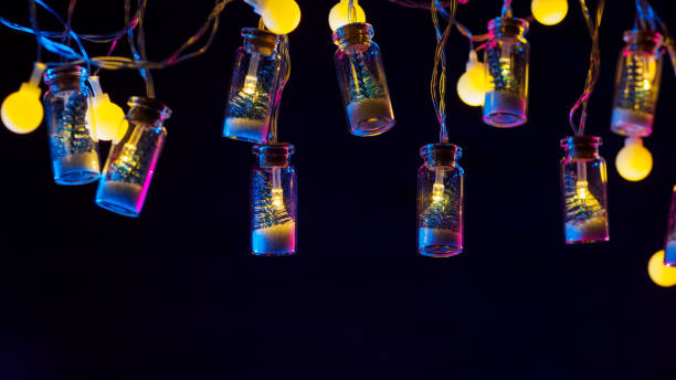 istock Christmas background, small Christmas tree in a glass jar garland , neon lighting, copyspace 1351299637